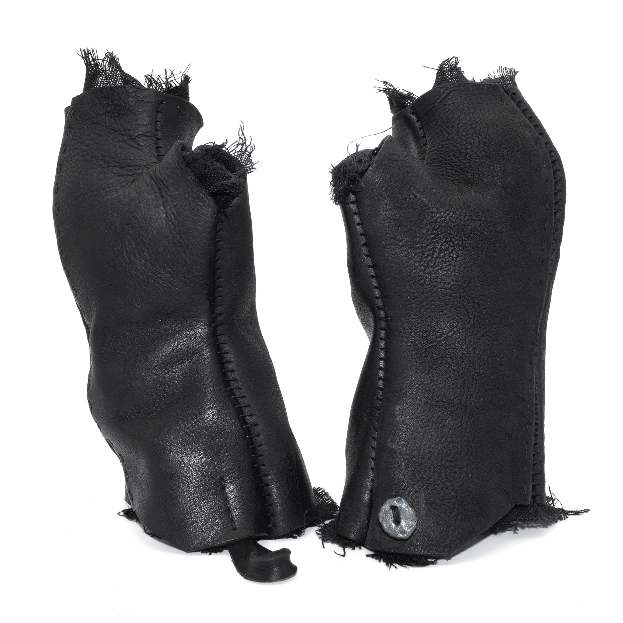 hand stitched over a 35hr period the washed cordovan gloves feature deconstructed open seam panels, hand forged solid .999 sterling silver button and a raw cut stone washed ramie lining. the gloves are available to buy online from avant garde leather studio atelierskn.com