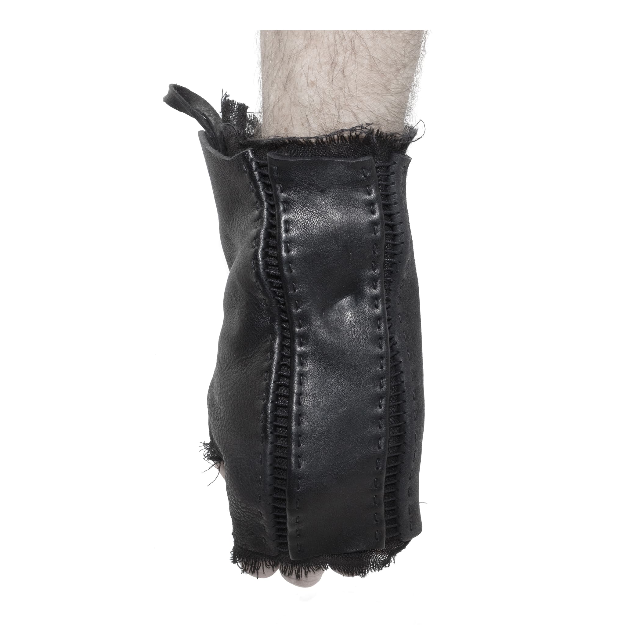 hand stitched over a 35hr period the washed cordovan gloves feature deconstructed open seam panels, hand forged solid .999 sterling silver button and a raw cut stone washed ramie lining. the gloves are available to buy online from avant garde leather studio atelierskn.com