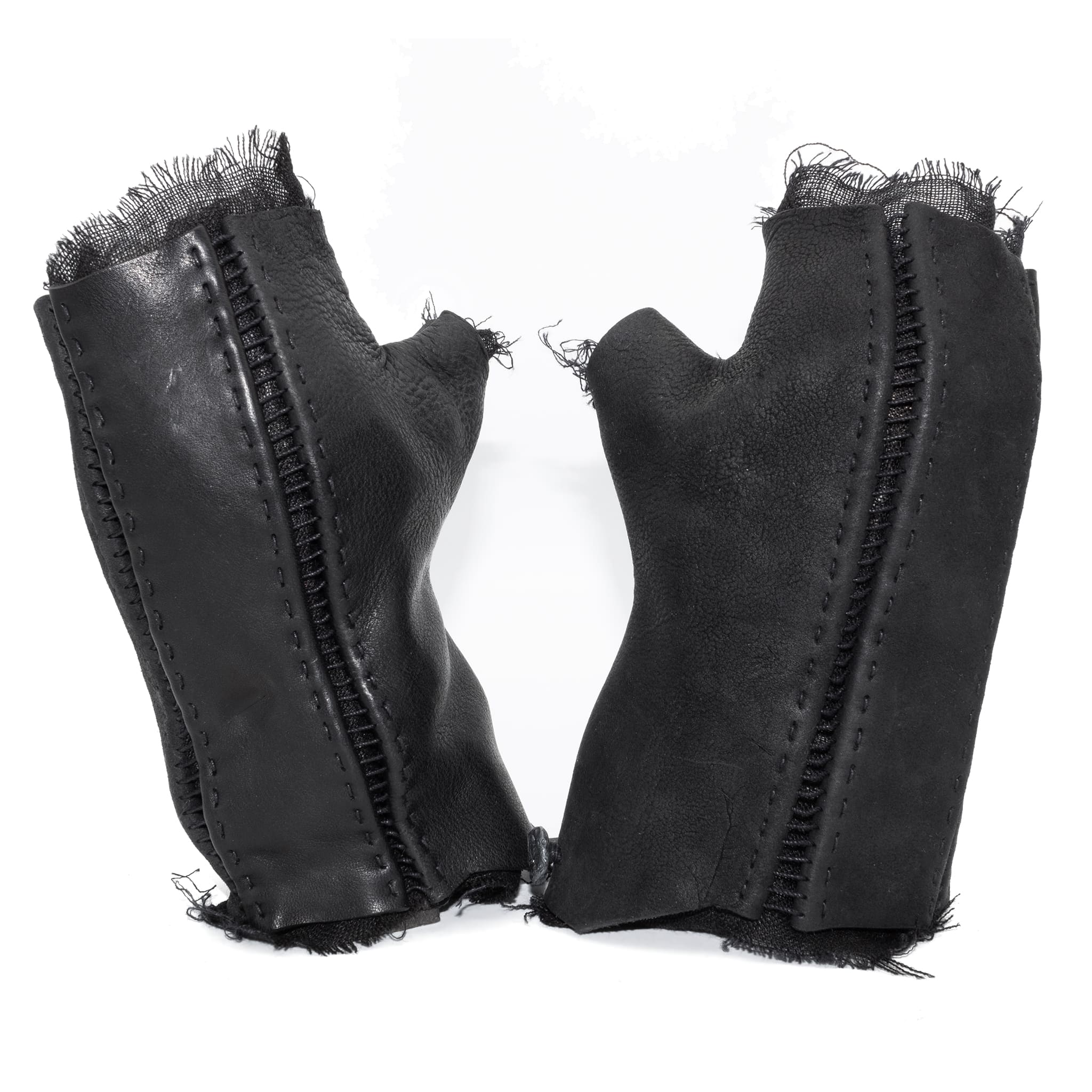 hand stitched over a 35hr period the washed cordovan gloves feature deconstructed open seam panels, hand forged solid .999 sterling silver button and a raw cut stone washed ramie lining. the gloves are available to buy online from avant garde leather studio atelierskn.com
