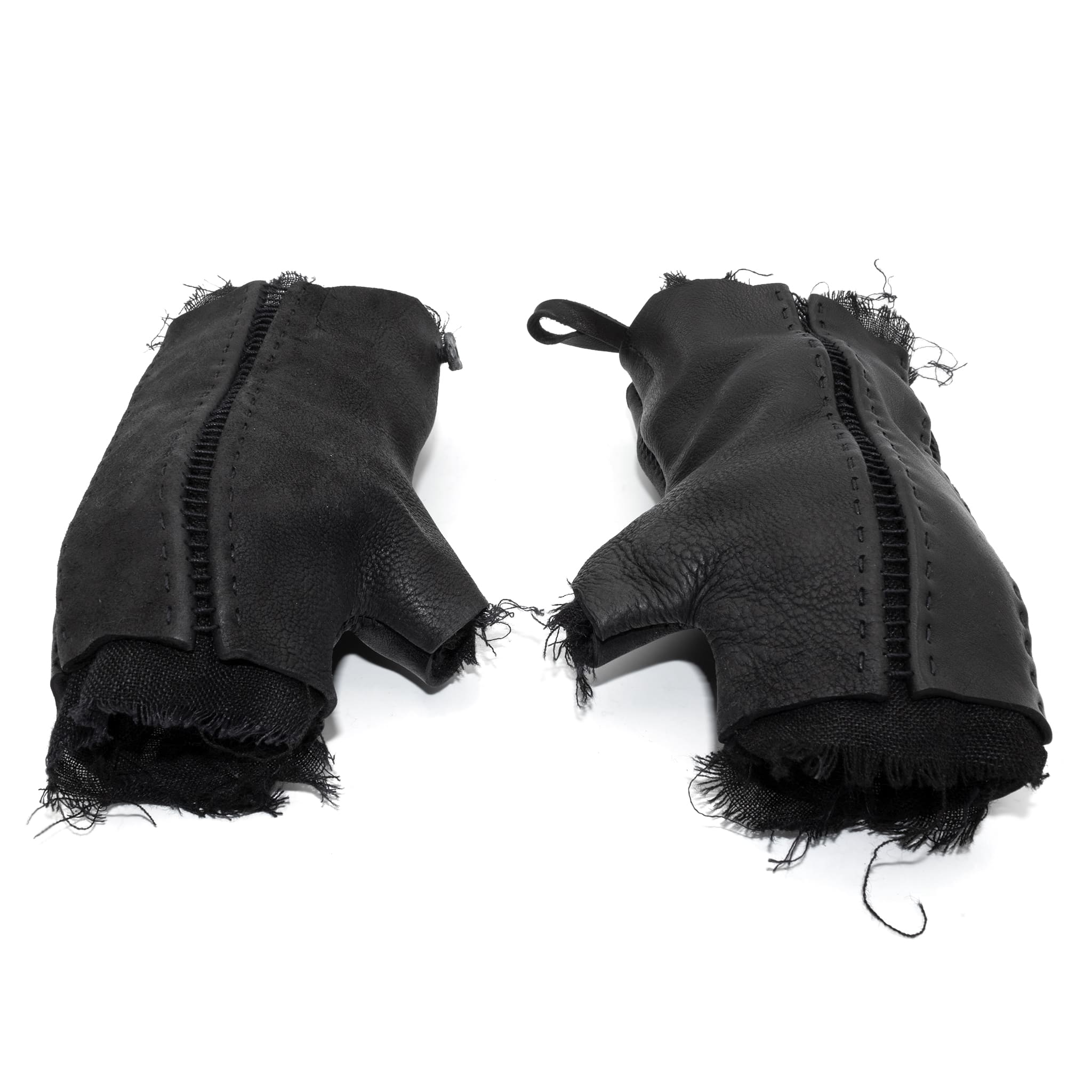 hand stitched over a 35hr period the washed cordovan gloves feature deconstructed open seam panels, hand forged solid .999 sterling silver button and a raw cut stone washed ramie lining. the gloves are available to buy online from avant garde leather studio atelierskn.com