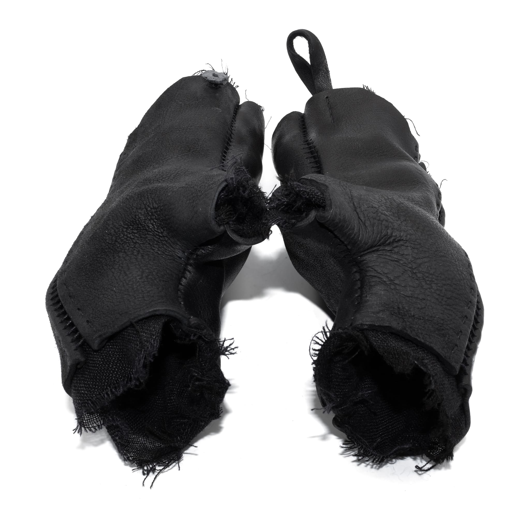 hand stitched over a 35hr period the washed cordovan gloves feature deconstructed open seam panels, hand forged solid .999 sterling silver button and a raw cut stone washed ramie lining. the gloves are available to buy online from avant garde leather studio atelierskn.com