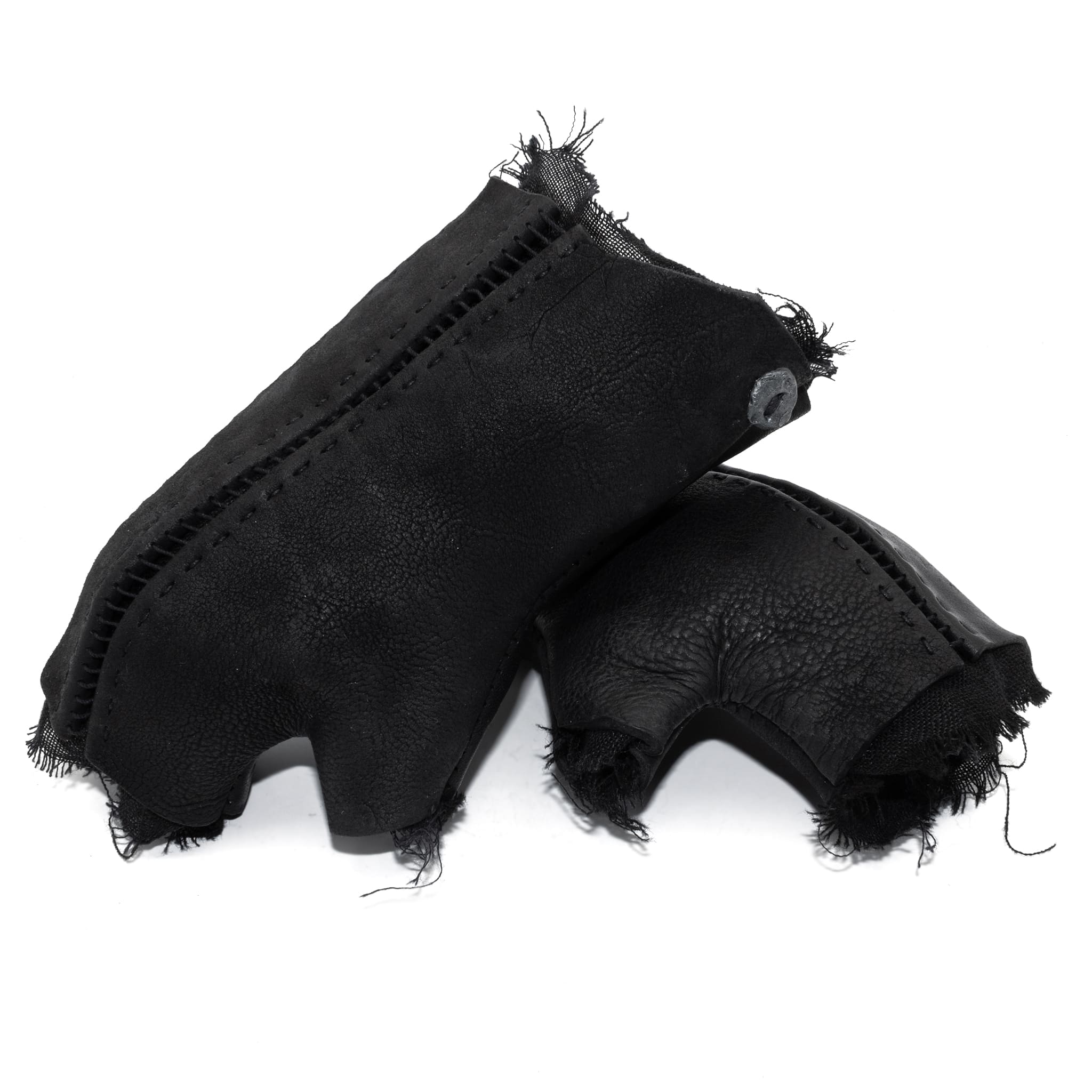 hand stitched over a 35hr period the washed cordovan gloves feature deconstructed open seam panels, hand forged solid .999 sterling silver button and a raw cut stone washed ramie lining. the gloves are available to buy online from avant garde leather studio atelierskn.com