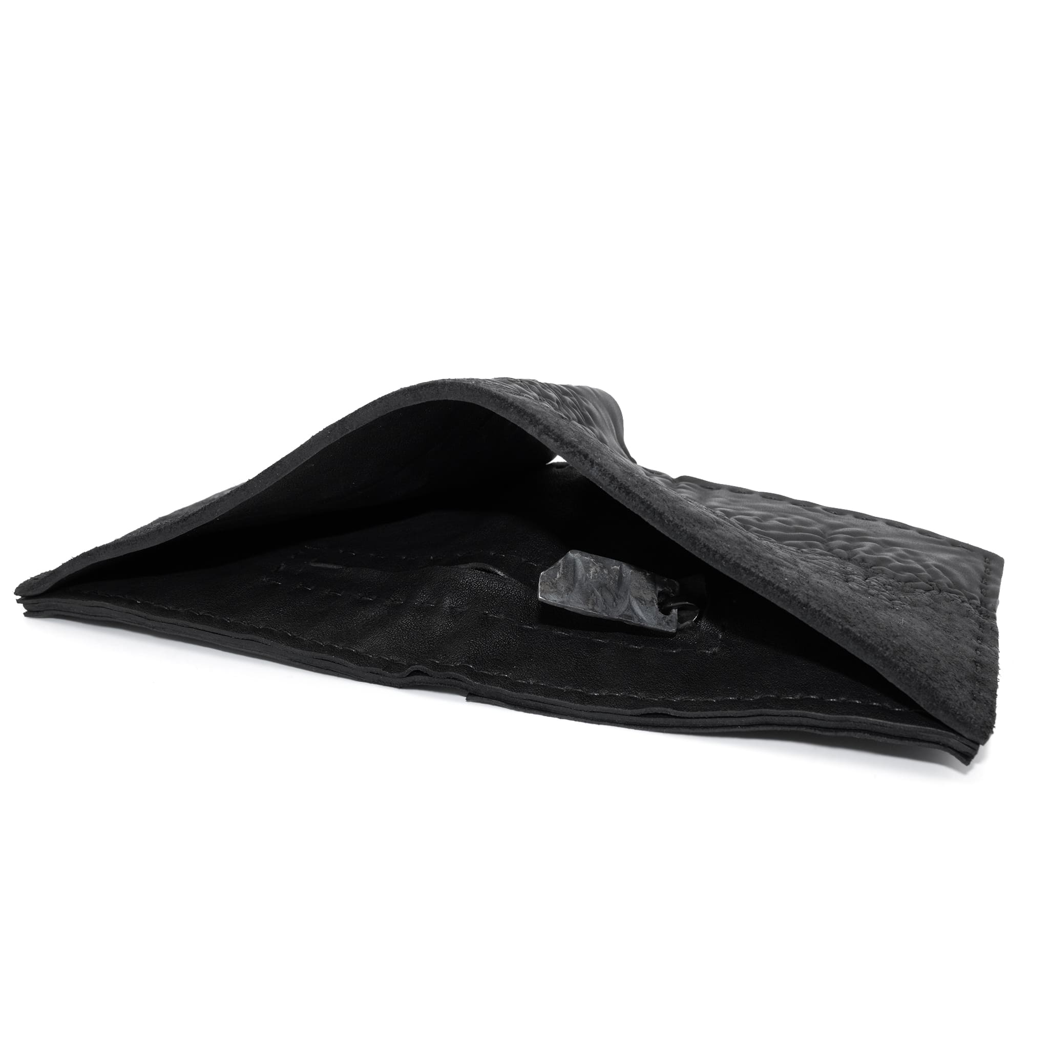 a closed seam 8 pocket bifold wallet crafted from a butter soft reverse culatta leather with a matte black object dyed finish. a riri zipper pocket is adorned with a hand forged solid .925sterling silver zipper pull available to buy online from artisanal leather studio atelierskn.com