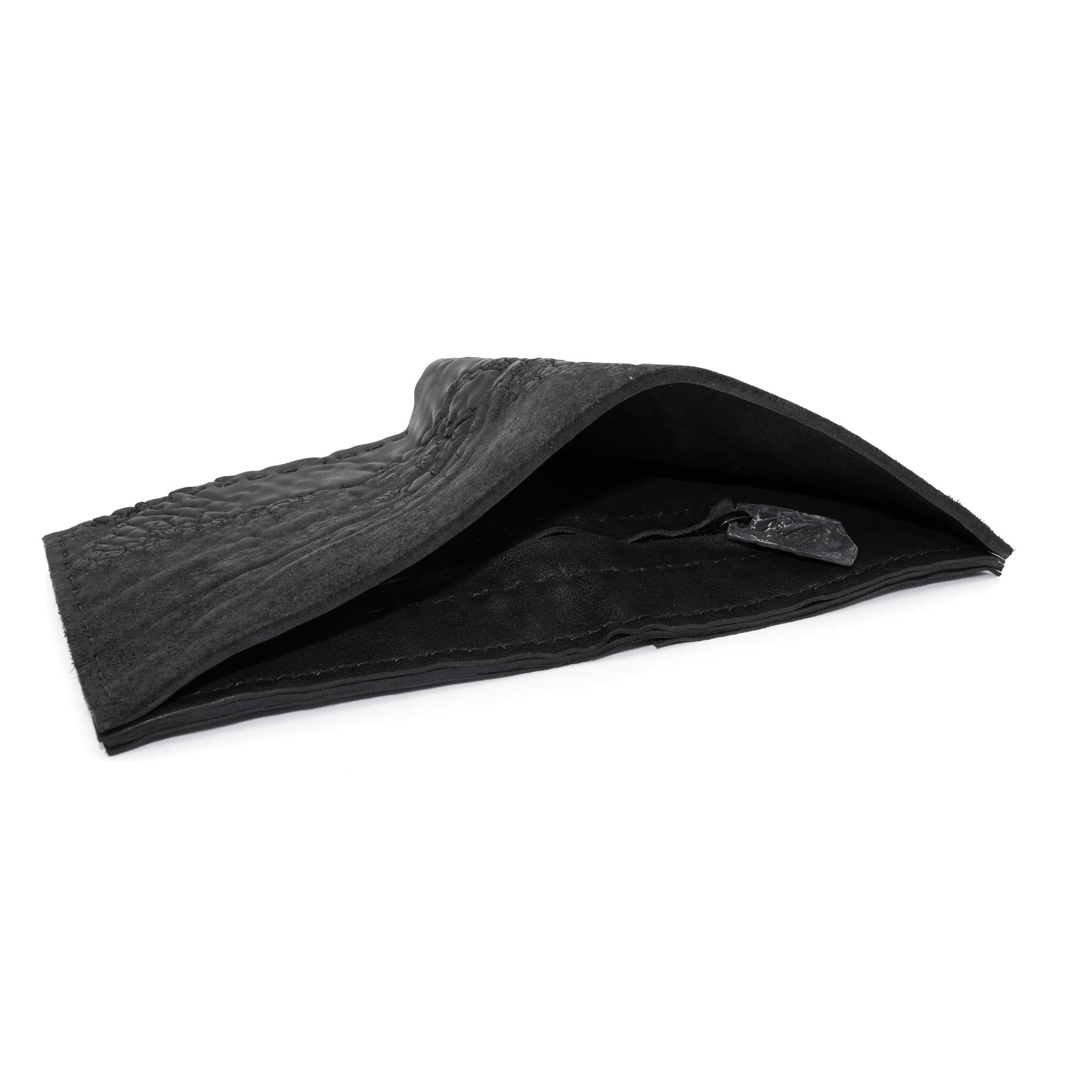 a closed seam 8 pocket bifold wallet crafted from a butter soft reverse culatta leather with a matte black object dyed finish. a riri zipper pocket is adorned with a hand forged solid .925sterling silver zipper pull available to buy online from artisanal leather studio atelierskn.com