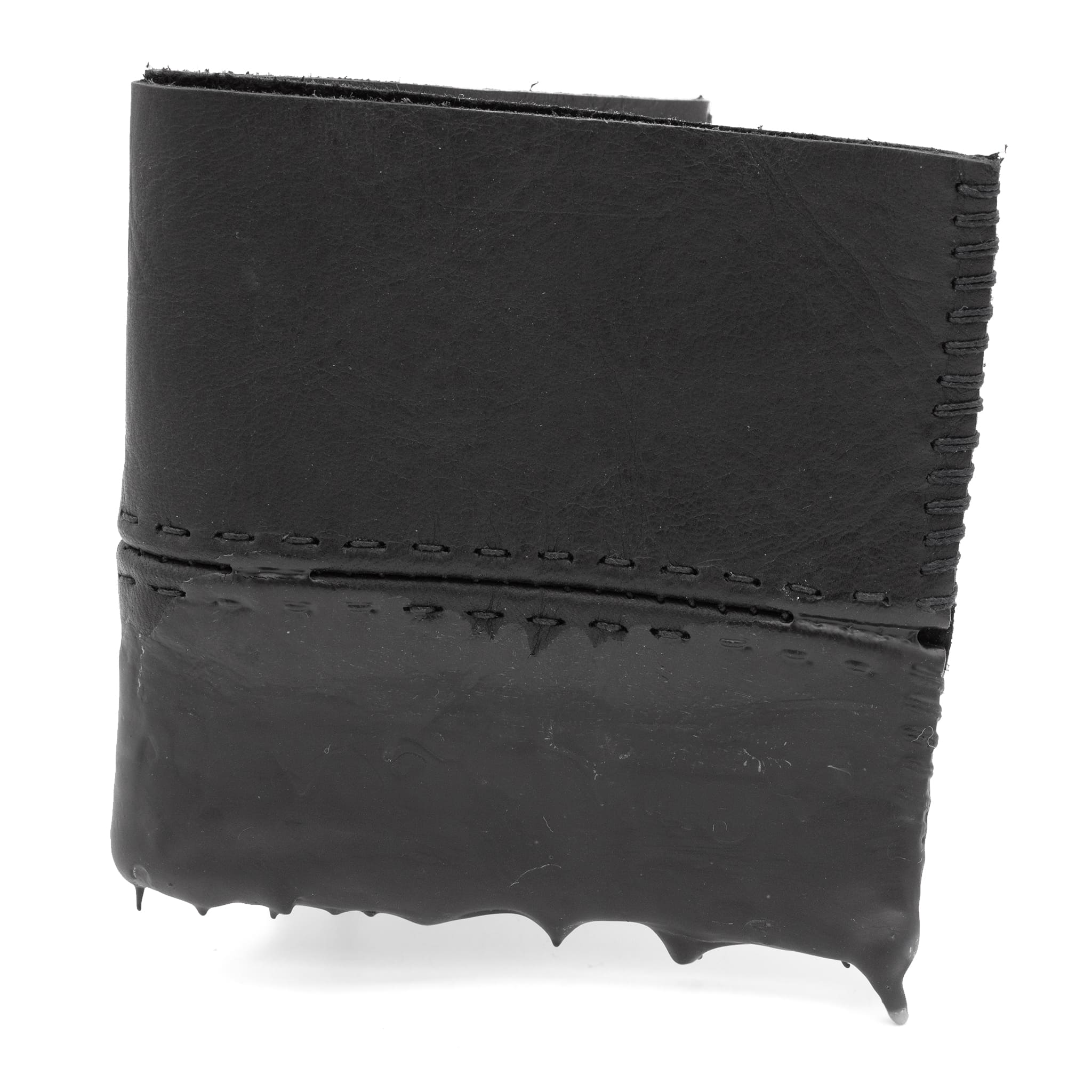 a closed seam 4 pocket bifold wallet crafted from a supple matte black washed horse leather with a closed seam construction. the wallet features a tonal rubber drip and is available to buy online from artisanal leather studio atelierskn.com
