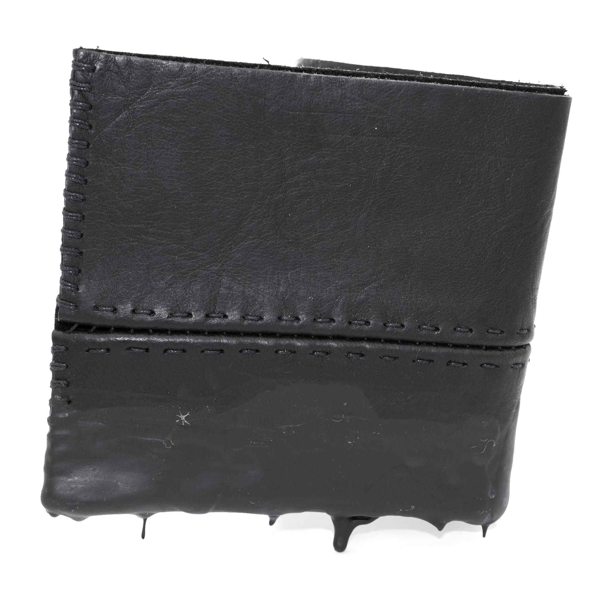 a closed seam 4 pocket bifold wallet crafted from a supple matte black washed horse leather with a closed seam construction. the wallet features a tonal rubber drip and is available to buy online from artisanal leather studio atelierskn.com