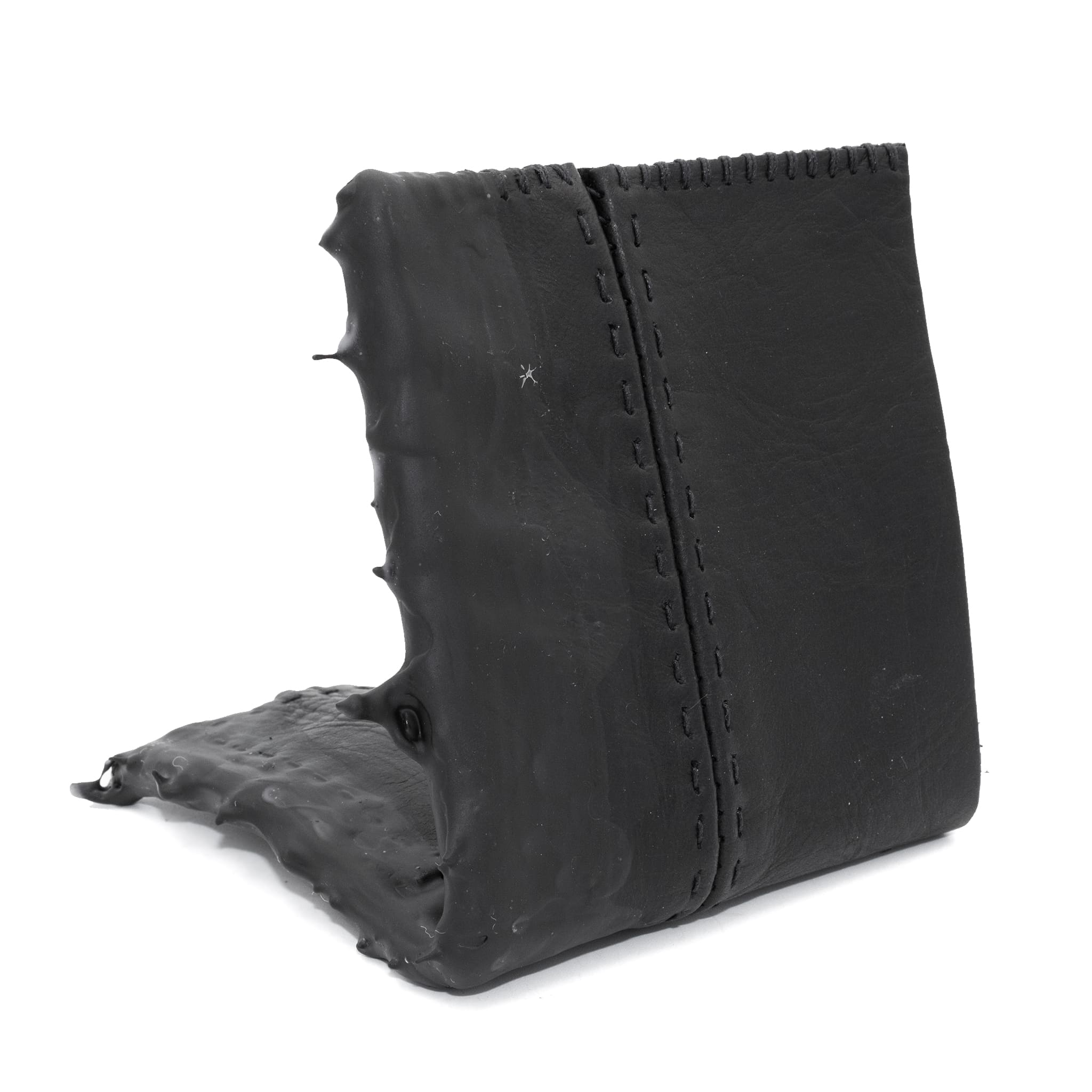 a closed seam 4 pocket bifold wallet crafted from a supple matte black washed horse leather with a closed seam construction. the wallet features a tonal rubber drip and is available to buy online from artisanal leather studio atelierskn.com