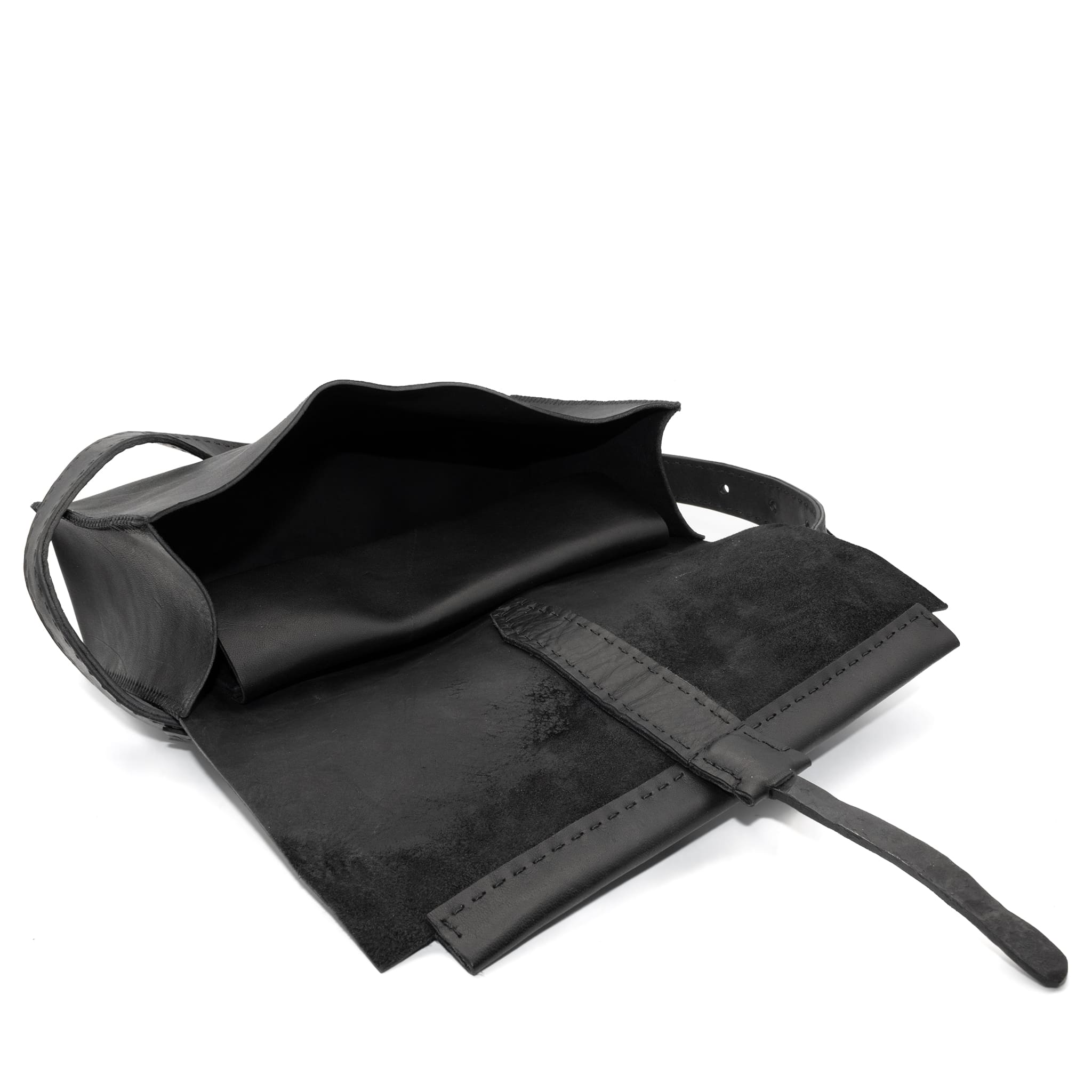 meticulously hand sewn, the washed horse leather landscape shoulder bag is crafted from a single piece pattern and features a minimal silhouette, an object dye treatment, tonal linen stitching and hand forged iron hardware. a large iron ring acts as a handle and an anchor for the detachable strap. the cross body bag is available to buy online from avant garde designer atelierskn.com