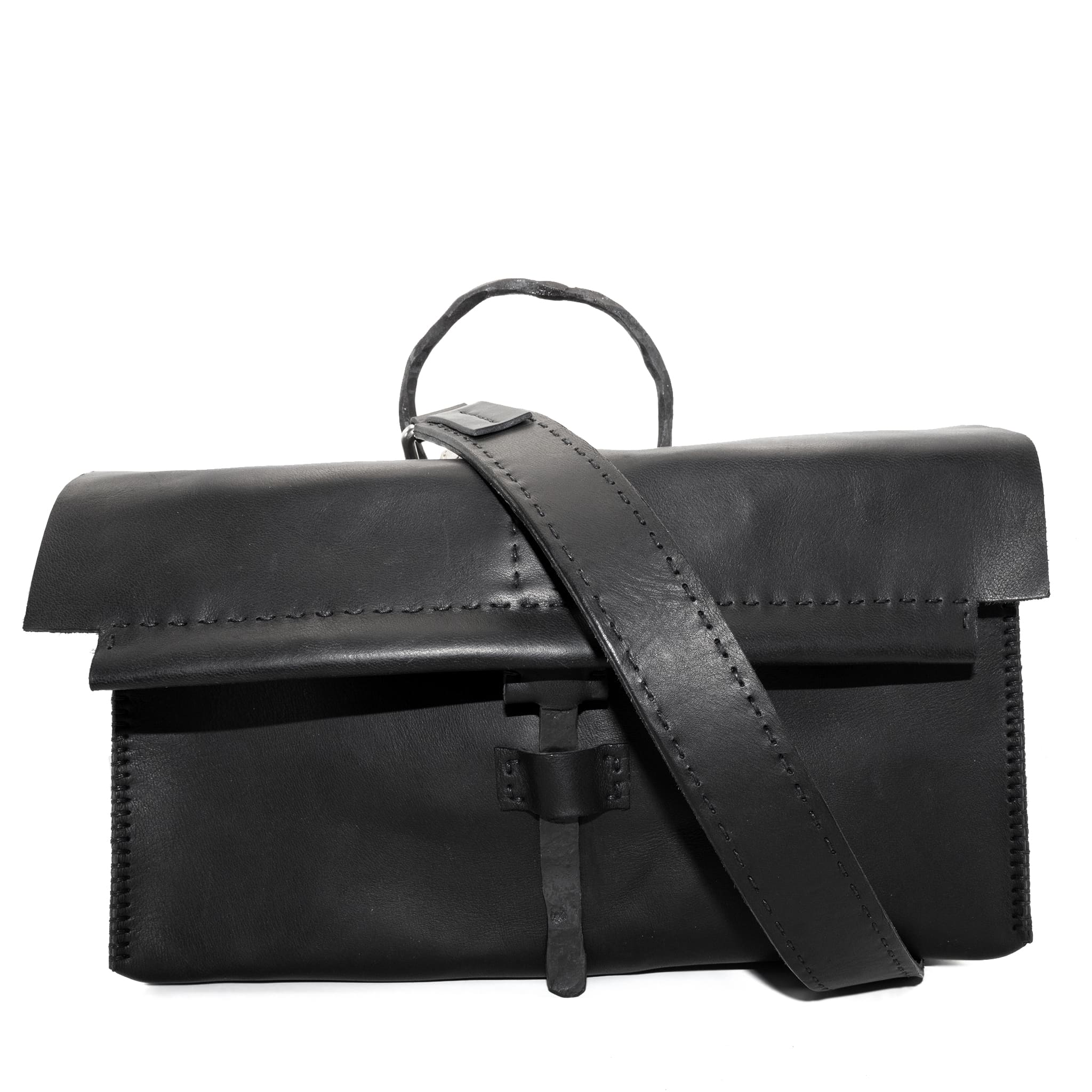 meticulously hand sewn, the washed horse leather landscape shoulder bag is crafted from a single piece pattern and features a minimal silhouette, an object dye treatment, tonal linen stitching and hand forged iron hardware. a large iron ring acts as a handle and an anchor for the detachable strap. the cross body bag is available to buy online from avant garde designer atelierskn.com