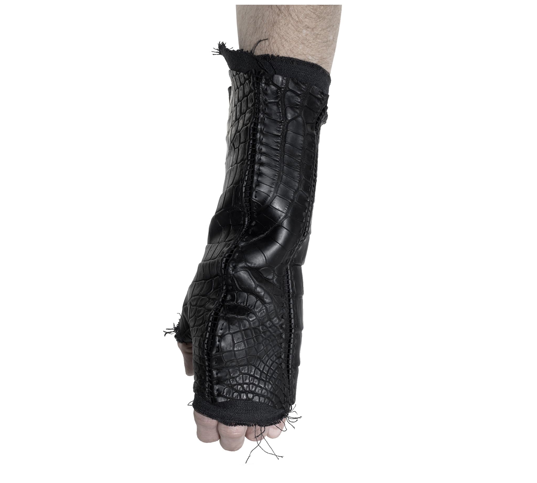 hand stitched over a 40hr period the genuine crocodile leather gloves feature deconstructed open seam panels, and a raw cut stone washed ramie lining. with an object dyed finish the gloves are then wet moulded on the body over an 8 hour period for a sculptured aesthetic. the gloves are available to buy online from avant garde leather studio atelierskn.com