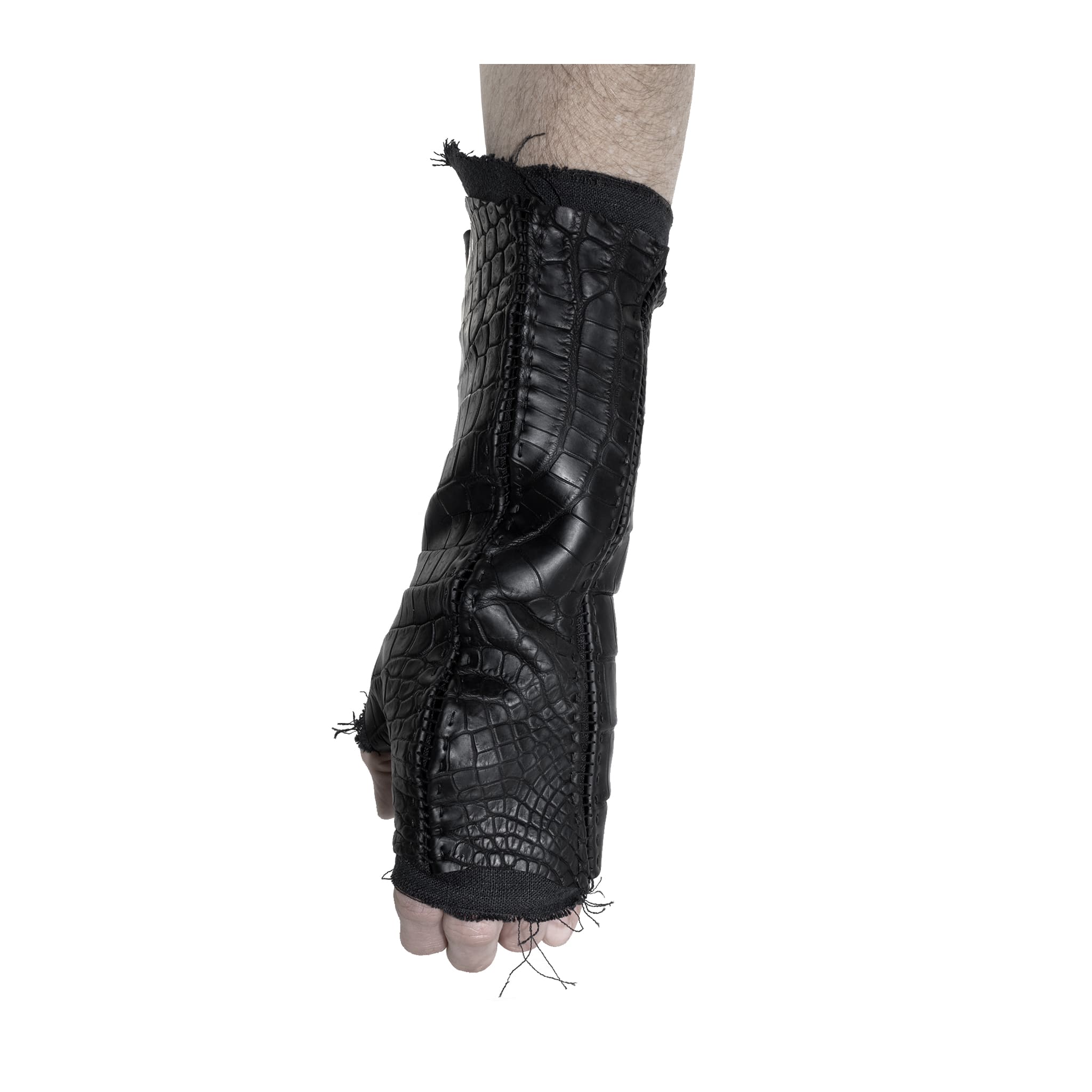 hand stitched over a 40hr period the genuine crocodile leather gloves feature deconstructed open seam panels, and a raw cut stone washed ramie lining. with an object dyed finish the gloves are then wet moulded on the body over an 8 hour period for a sculptured aesthetic. the gloves are available to buy online from avant garde leather studio atelierskn.com