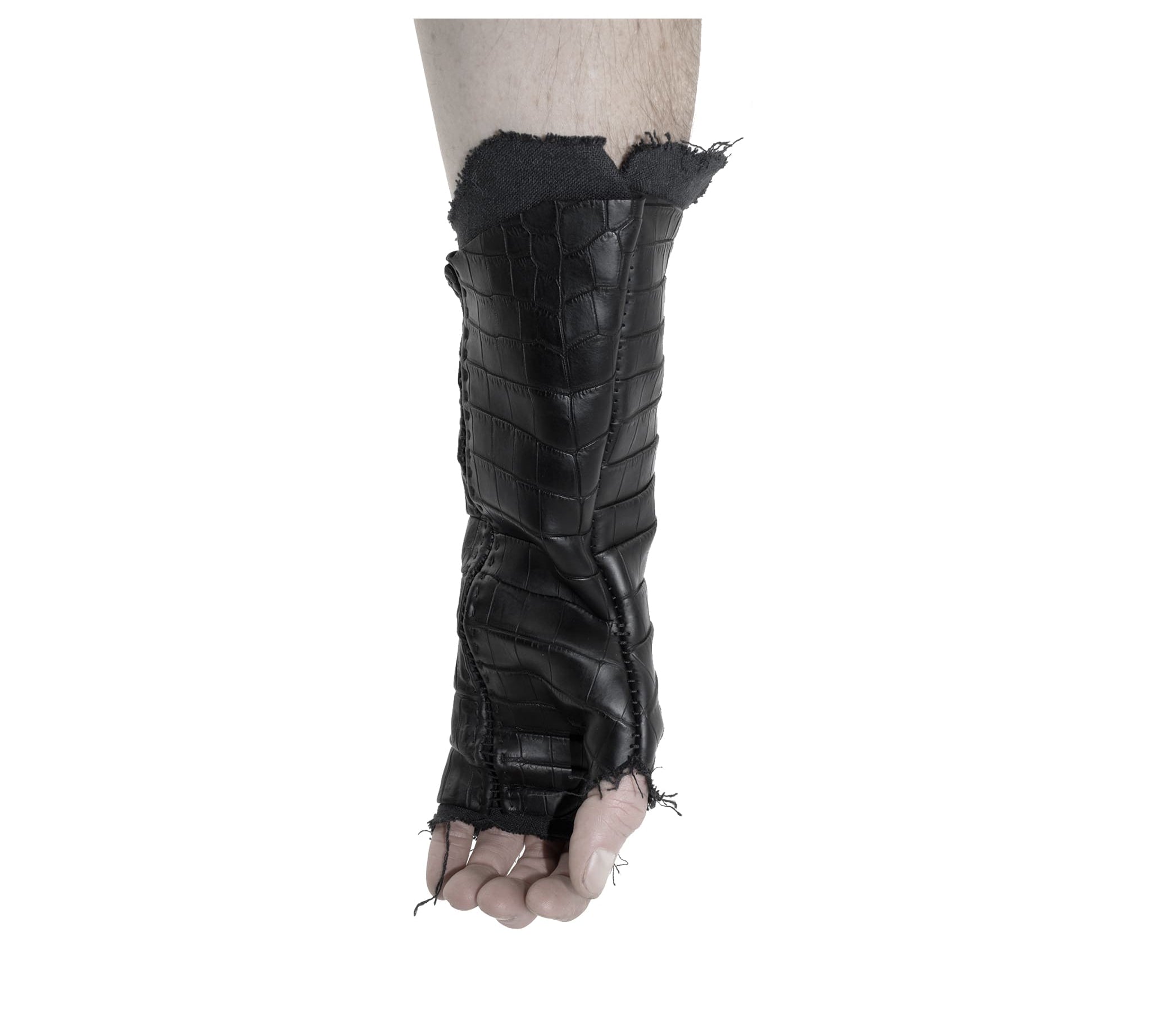 hand stitched over a 40hr period the genuine crocodile leather gloves feature deconstructed open seam panels, and a raw cut stone washed ramie lining. with an object dyed finish the gloves are then wet moulded on the body over an 8 hour period for a sculptured aesthetic. the gloves are available to buy online from avant garde leather studio atelierskn.com