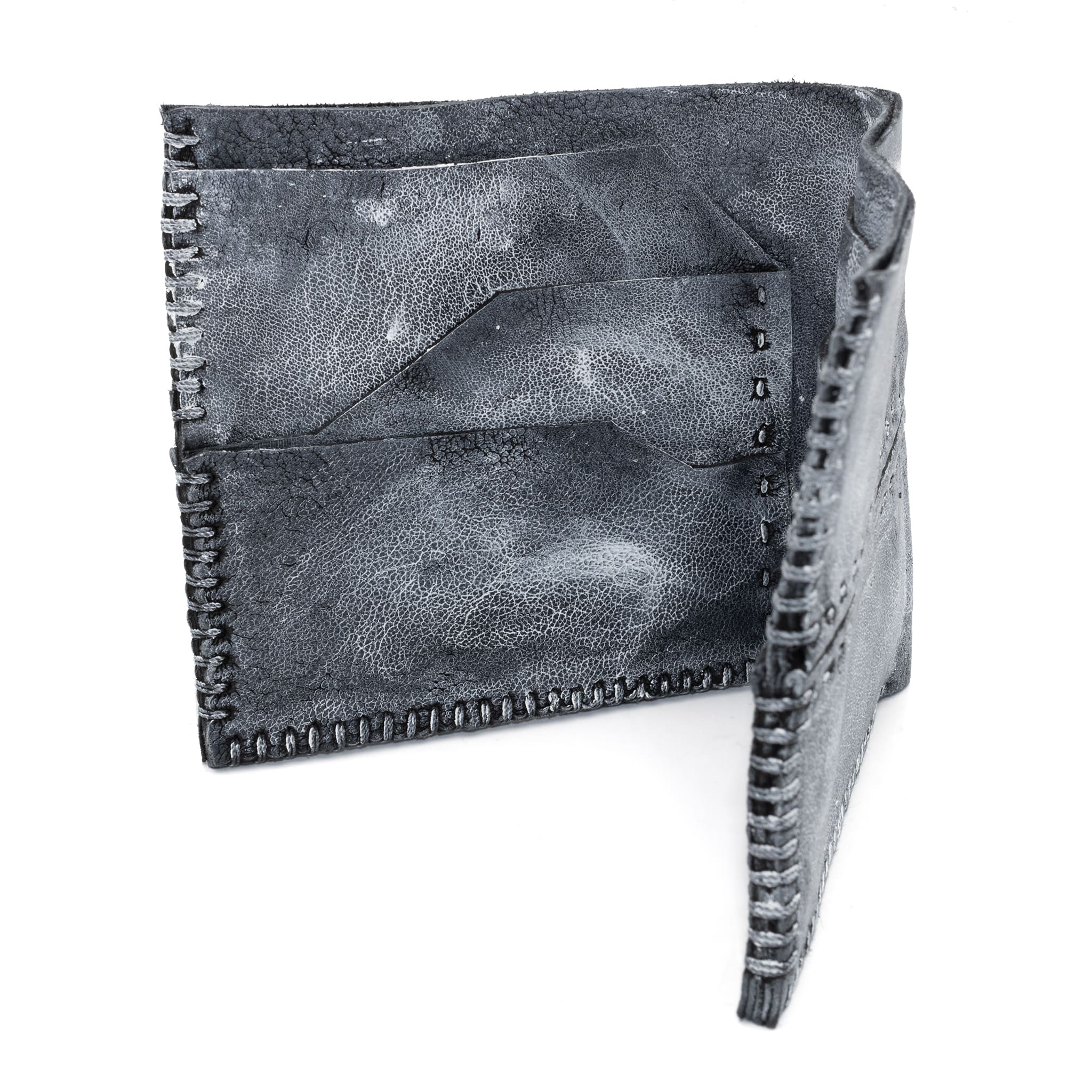 a closed seam 6 pocket bifold wallet crafted from a supple matte black kangaroo leather with a contrasting pigmented wax finish available to buy online from artisanal leather studio atelierskn.com