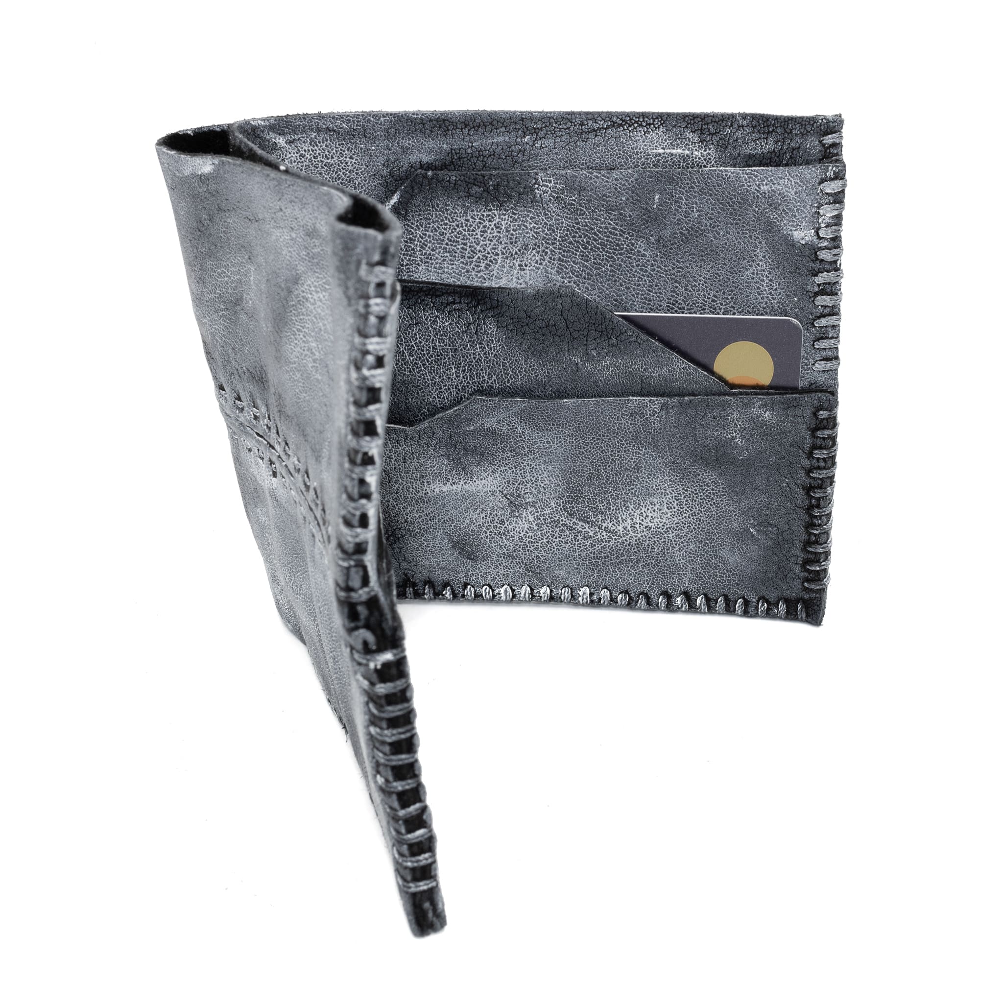 a closed seam 6 pocket bifold wallet crafted from a supple matte black kangaroo leather with a contrasting pigmented wax finish available to buy online from artisanal leather studio atelierskn.com