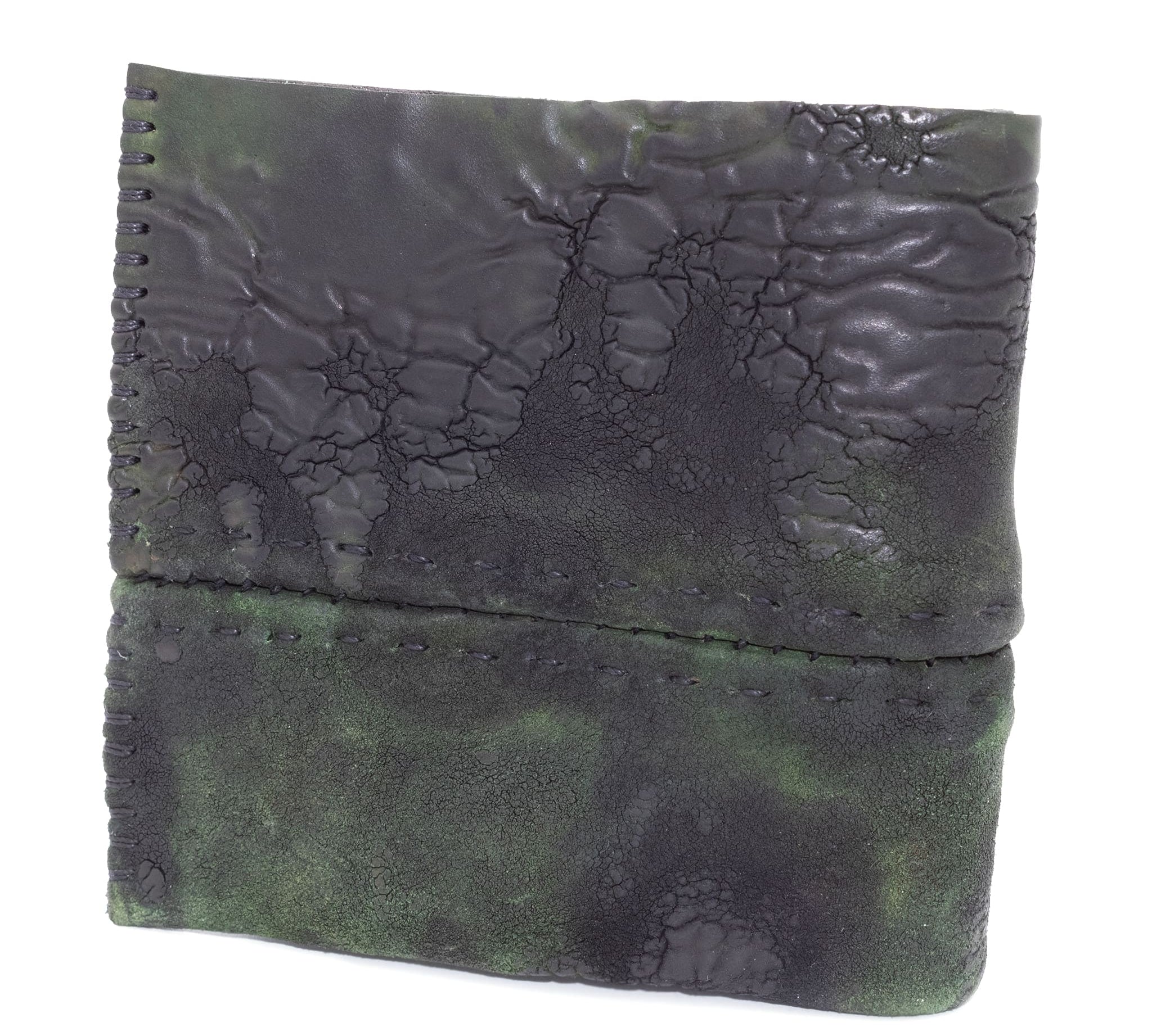 object dyed reverse horse culatta leather bifold wallet, meticulously hand stitched with a closed seam construction. multiple card pockets to the interior sit alongside a large note compartment. the wallet is available to buy online from atelierskn.com