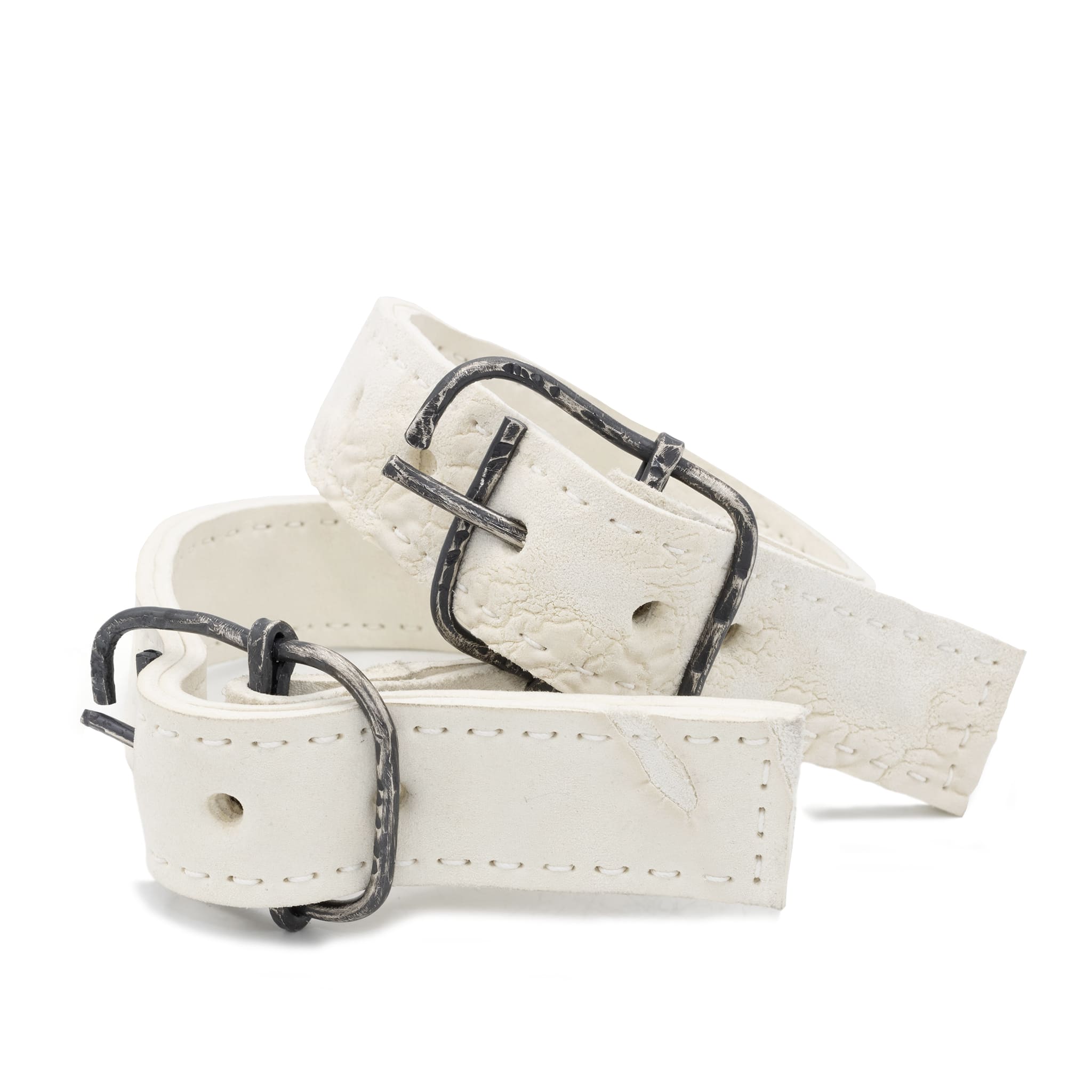 avant garde hand stitched horse culatta leather bicep belts, in a crushed bone finish. the arm cuffs feature a minimal silhouette with tonal japanese linen stitching and a hand forged .925 sterling silver buckle hardware. the arm belts are available to buy online from artisanal designer atelierskn.com 