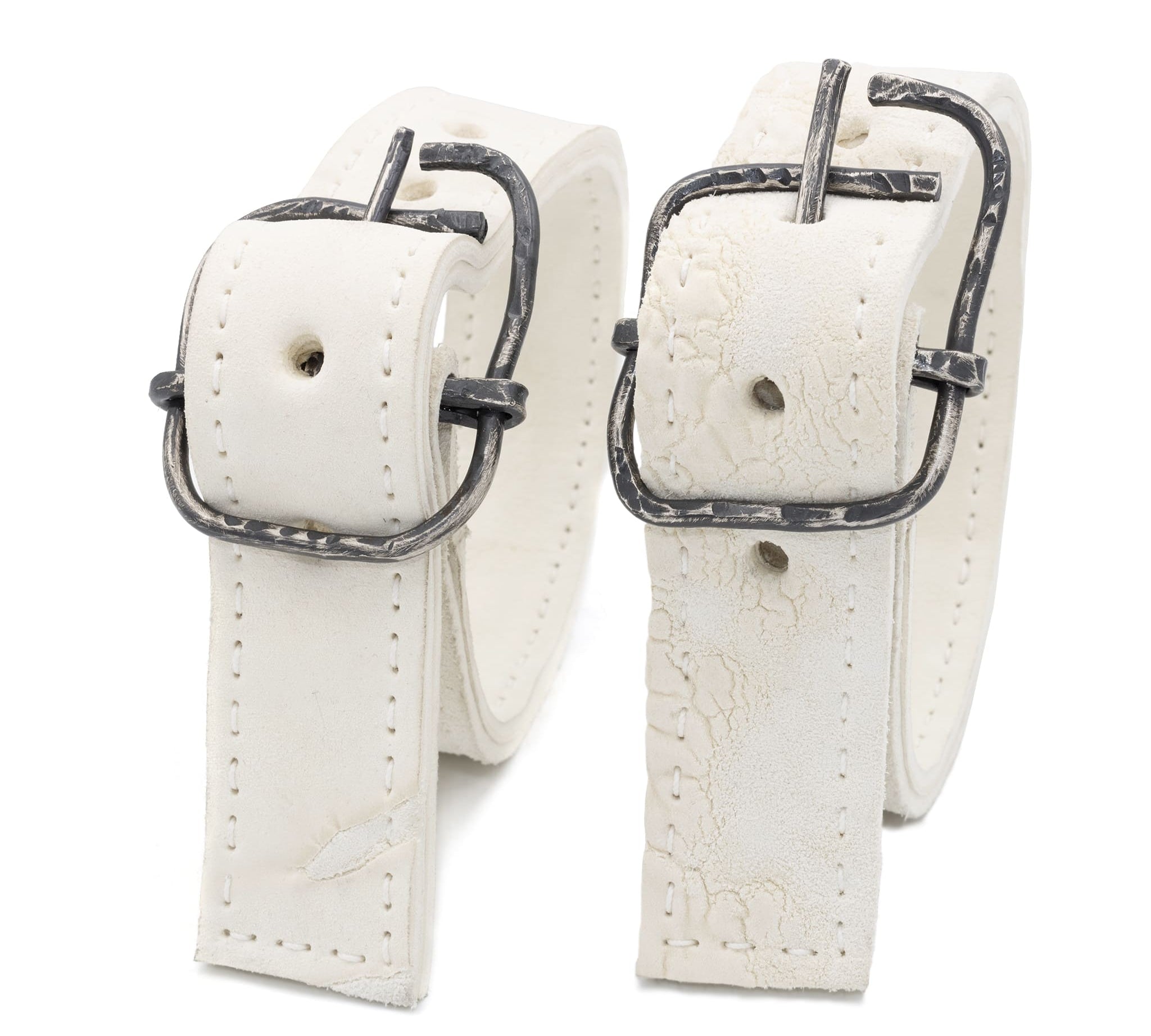 avant garde hand stitched horse culatta leather bicep belts, in a crushed bone finish. the arm cuffs feature a minimal silhouette with tonal japanese linen stitching and a hand forged .925 sterling silver buckle hardware. the arm belts are available to buy online from artisanal designer atelierskn.com 