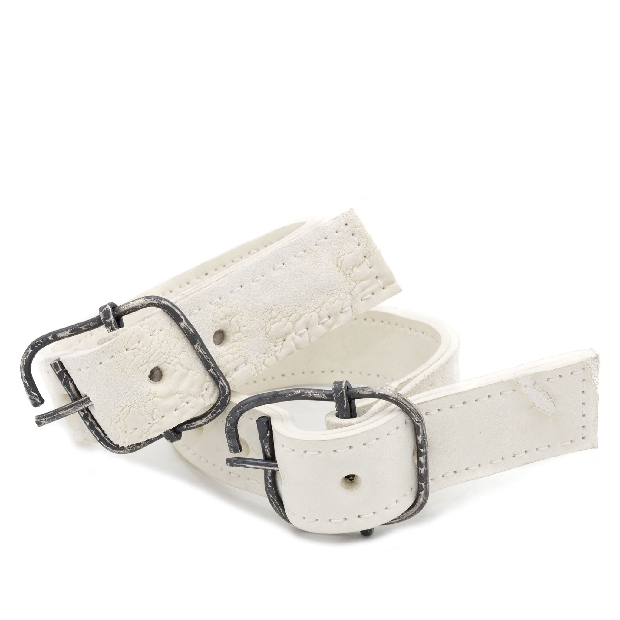 avant garde hand stitched horse culatta leather bicep belts, in a crushed bone finish. the arm cuffs feature a minimal silhouette with tonal japanese linen stitching and a hand forged .925 sterling silver buckle hardware. the arm belts are available to buy online from artisanal designer atelierskn.com 
