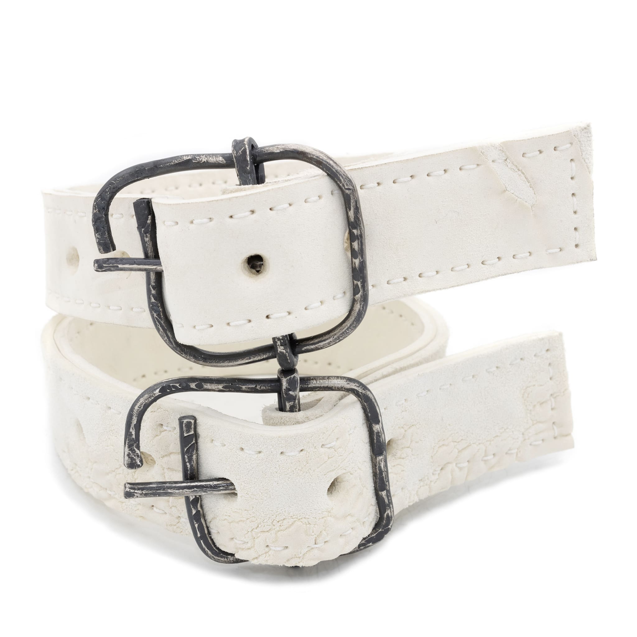 avant garde hand stitched horse culatta leather bicep belts, in a crushed bone finish. the arm cuffs feature a minimal silhouette with tonal japanese linen stitching and a hand forged .925 sterling silver buckle hardware. the arm belts are available to buy online from artisanal designer atelierskn.com 