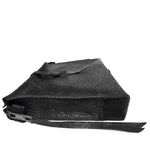 hand stitched over a 50hr period the washed cordovan clutch bag features deconstructed side panels, hand forged iron hardware and a riri zipper closure adorned with solid .925 sterling silver zipper pulls. the bag is available to buy online from avant garde leather studio atelierskn.com