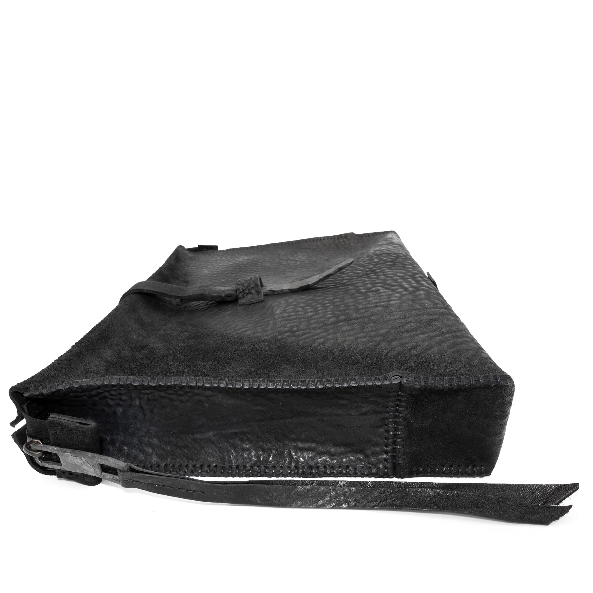 hand stitched over a 50hr period the washed cordovan clutch bag features deconstructed side panels, hand forged iron hardware and a riri zipper closure adorned with solid .925 sterling silver zipper pulls. the bag is available to buy online from avant garde leather studio atelierskn.com