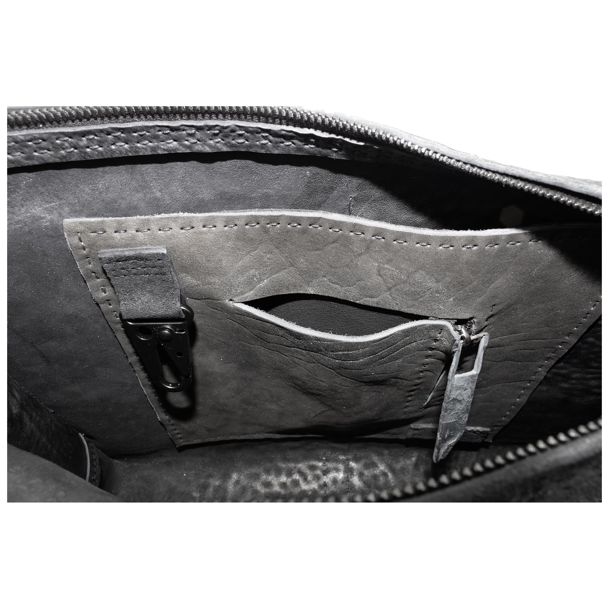 hand stitched over a 50hr period the washed cordovan clutch bag features deconstructed side panels, hand forged iron hardware and a riri zipper closure adorned with solid .925 sterling silver zipper pulls. the bag is available to buy online from avant garde leather studio atelierskn.com