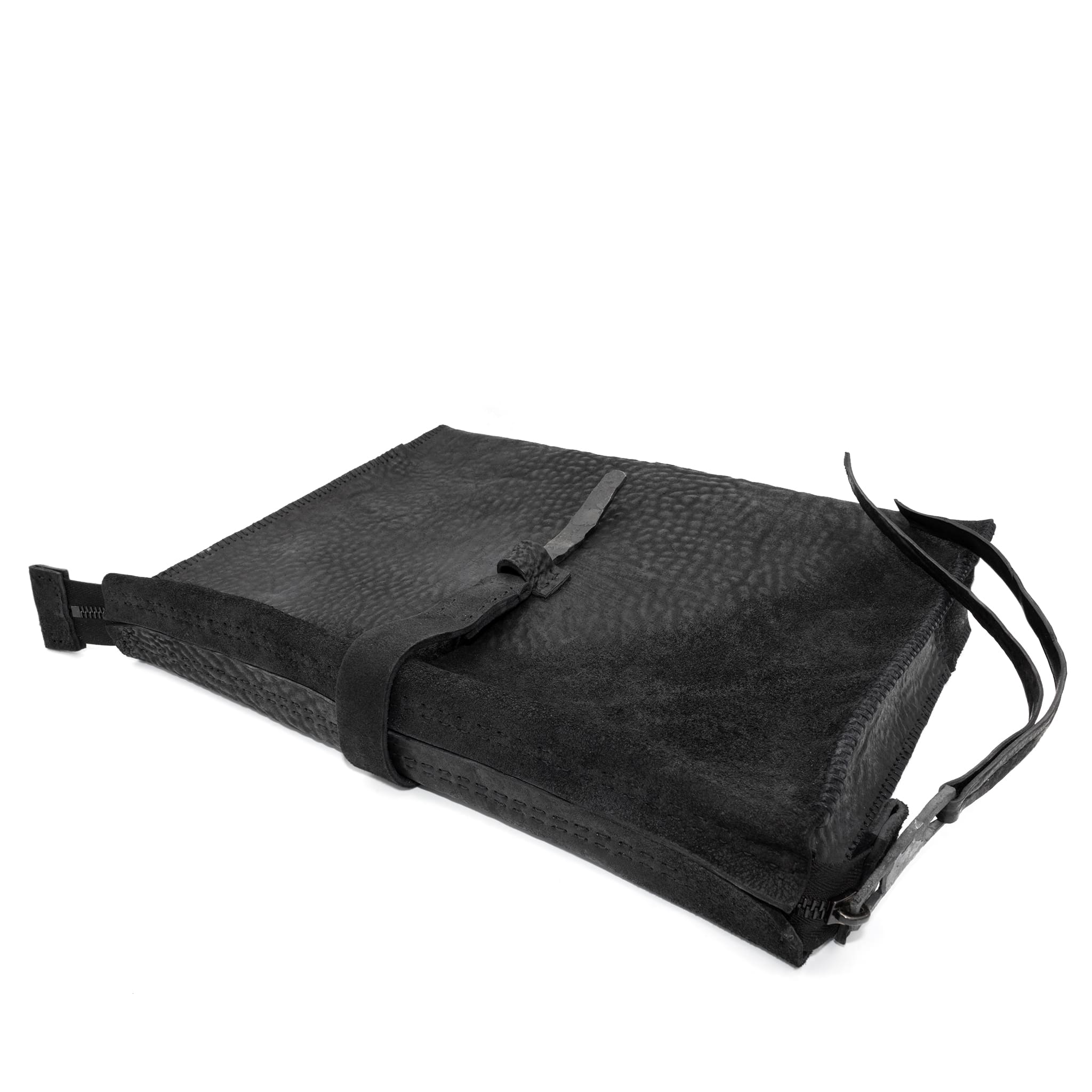hand stitched over a 50hr period the washed cordovan clutch bag features deconstructed side panels, hand forged iron hardware and a riri zipper closure adorned with solid .925 sterling silver zipper pulls. the bag is available to buy online from avant garde leather studio atelierskn.com