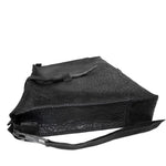 hand stitched over a 50hr period the washed cordovan clutch bag features deconstructed side panels, hand forged iron hardware and a riri zipper closure adorned with solid .925 sterling silver zipper pulls. the bag is available to buy online from avant garde leather studio atelierskn.com