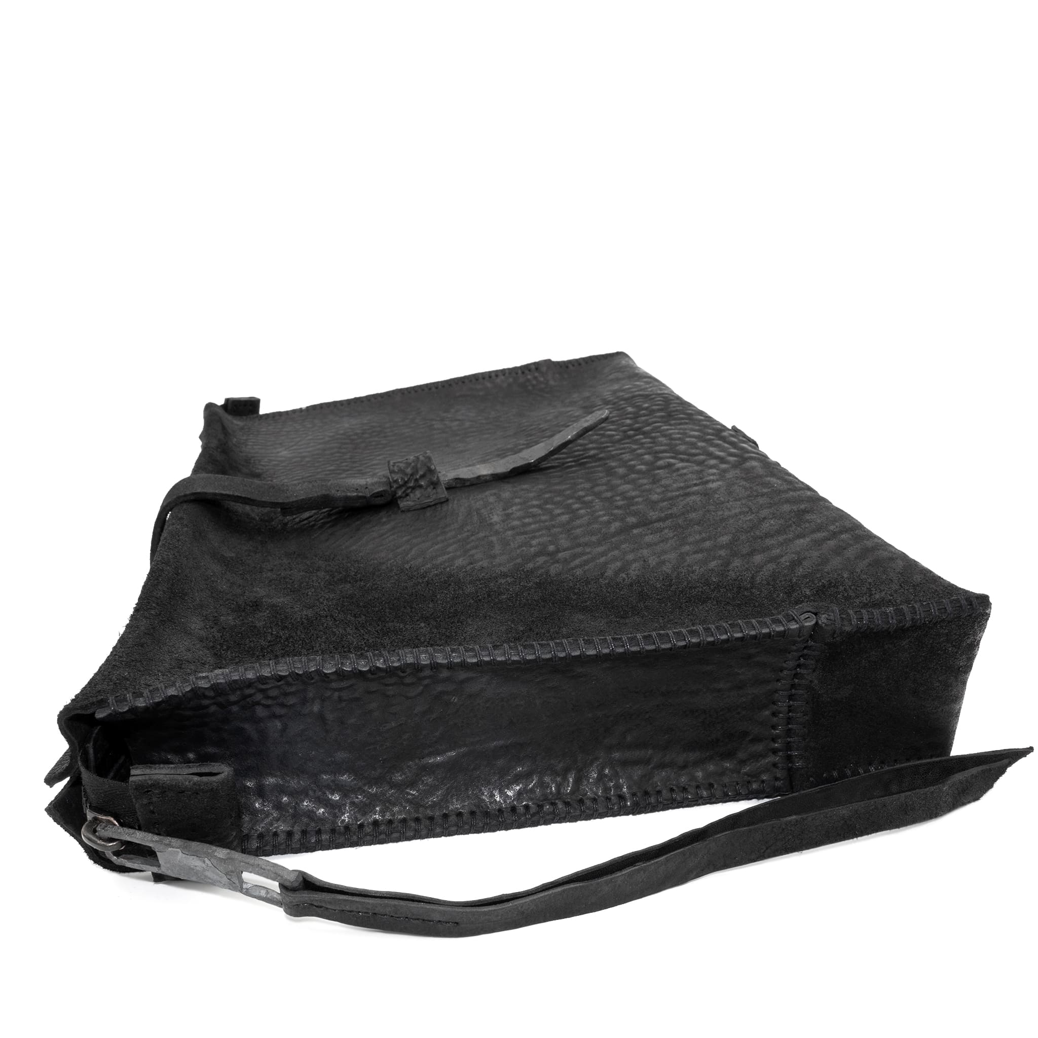 hand stitched over a 50hr period the washed cordovan clutch bag features deconstructed side panels, hand forged iron hardware and a riri zipper closure adorned with solid .925 sterling silver zipper pulls. the bag is available to buy online from avant garde leather studio atelierskn.com