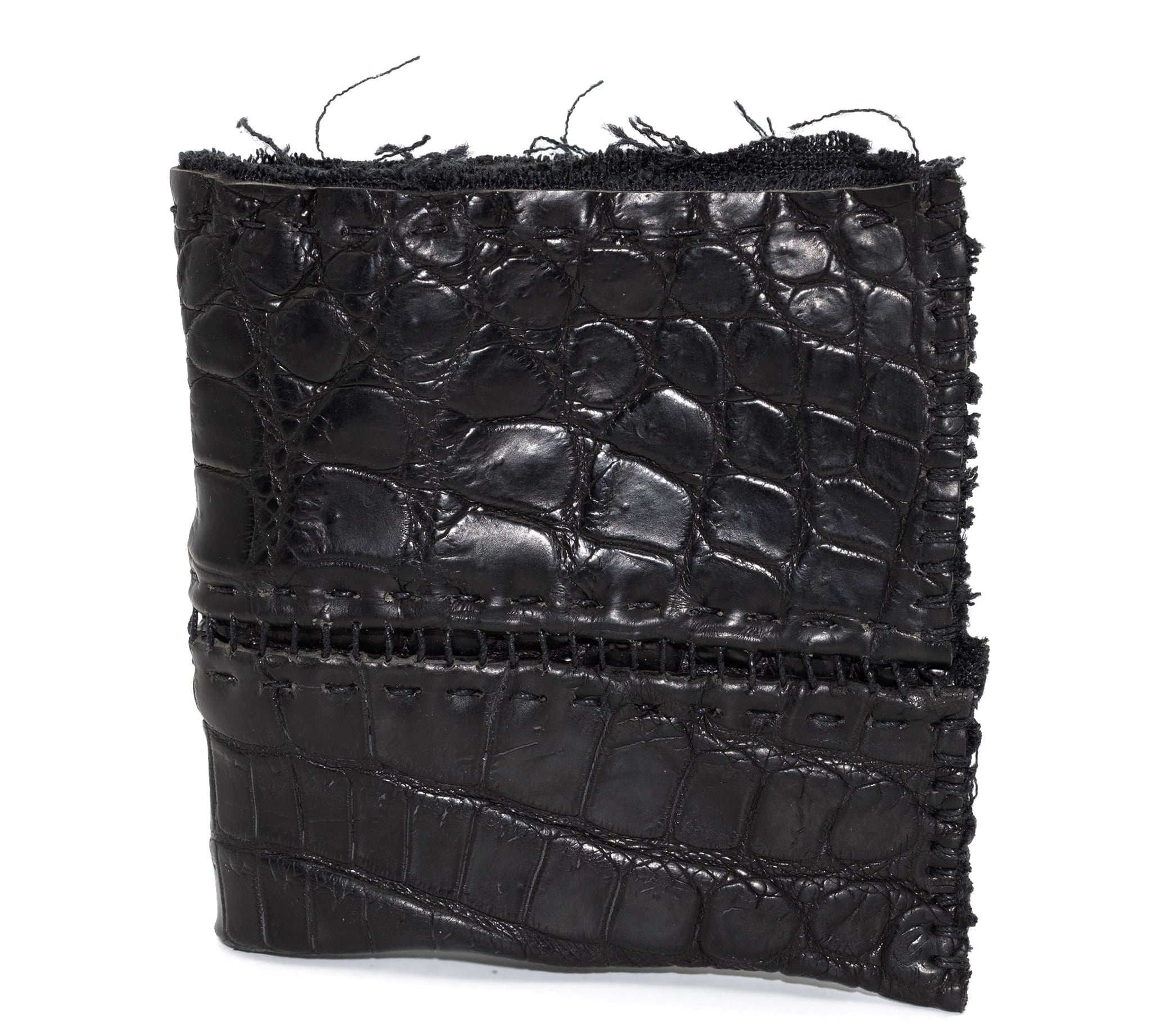 black crocodile leather wallet hand stitched over a 10 hour period. the genuine crocodile leather bifold wallet features multiple card slots, and a japanese ramie lining. an open seam construction and overlocked sides are hand stitched in a japanese linen thread. the wallet is available to buy online from avant garde leather studio atelierskn.com