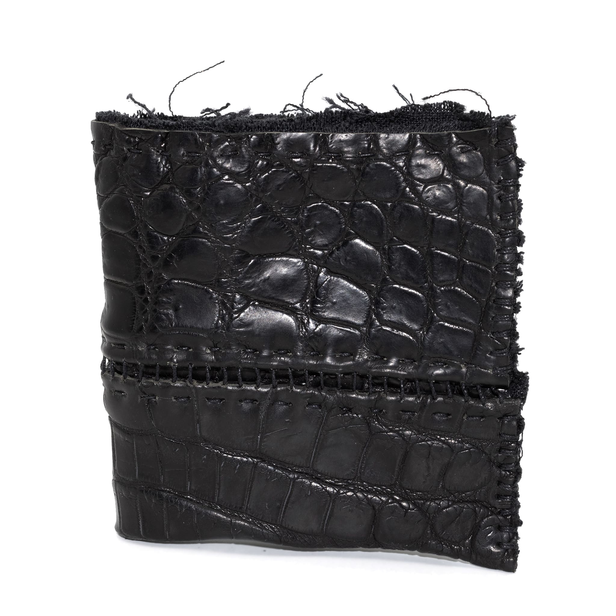 black crocodile leather wallet hand stitched over a 10 hour period. the genuine crocodile leather bifold wallet features multiple card slots, and a japanese ramie lining. an open seam construction and overlocked sides are hand stitched in a japanese linen thread. the wallet is available to buy online from avant garde leather studio atelierskn.com