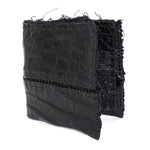 black crocodile leather wallet hand stitched over a 10 hour period. the genuine crocodile leather bifold wallet features multiple card slots, and a japanese ramie lining. an open seam construction and overlocked sides are hand stitched in a japanese linen thread. the wallet is available to buy online from avant garde leather studio atelierskn.com