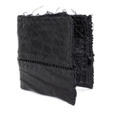 black crocodile leather wallet hand stitched over a 10 hour period. the genuine crocodile leather bifold wallet features multiple card slots, and a japanese ramie lining. an open seam construction and overlocked sides are hand stitched in a japanese linen thread. the wallet is available to buy online from avant garde leather studio atelierskn.com