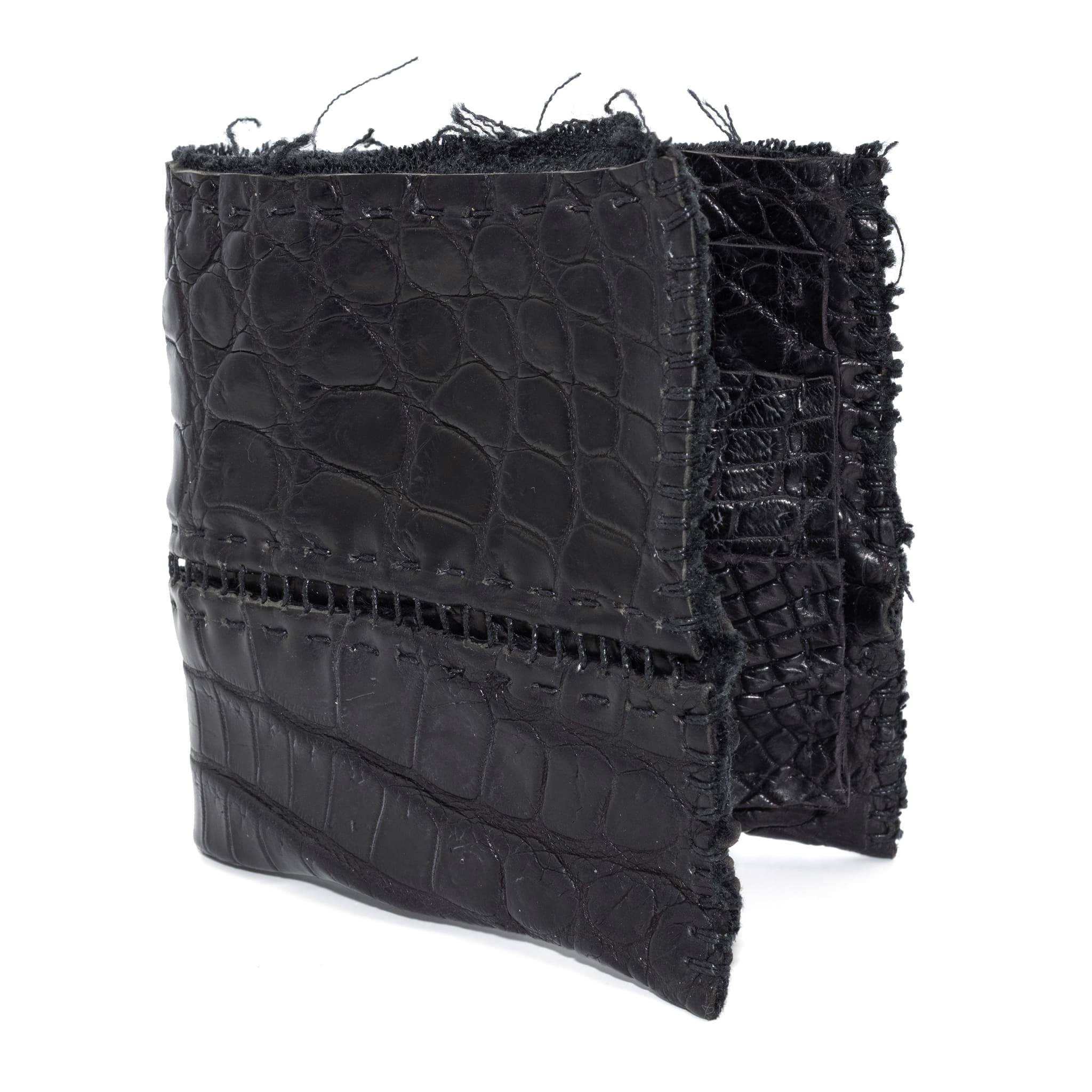 black crocodile leather wallet hand stitched over a 10 hour period. the genuine crocodile leather bifold wallet features multiple card slots, and a japanese ramie lining. an open seam construction and overlocked sides are hand stitched in a japanese linen thread. the wallet is available to buy online from avant garde leather studio atelierskn.com