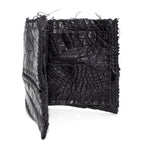 black crocodile leather wallet hand stitched over a 10 hour period. the genuine crocodile leather bifold wallet features multiple card slots, and a japanese ramie lining. an open seam construction and overlocked sides are hand stitched in a japanese linen thread. the wallet is available to buy online from avant garde leather studio atelierskn.com