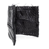 black crocodile leather wallet hand stitched over a 10 hour period. the genuine crocodile leather bifold wallet features multiple card slots, and a japanese ramie lining. an open seam construction and overlocked sides are hand stitched in a japanese linen thread. the wallet is available to buy online from avant garde leather studio atelierskn.com