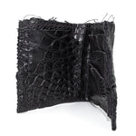 black crocodile leather wallet hand stitched over a 10 hour period. the genuine crocodile leather bifold wallet features multiple card slots, and a japanese ramie lining. an open seam construction and overlocked sides are hand stitched in a japanese linen thread. the wallet is available to buy online from avant garde leather studio atelierskn.com
