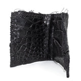 black crocodile leather wallet hand stitched over a 10 hour period. the genuine crocodile leather bifold wallet features multiple card slots, and a japanese ramie lining. an open seam construction and overlocked sides are hand stitched in a japanese linen thread. the wallet is available to buy online from avant garde leather studio atelierskn.com