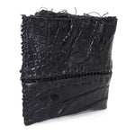black crocodile leather wallet hand stitched over a 10 hour period. the genuine crocodile leather bifold wallet features multiple card slots, and a japanese ramie lining. an open seam construction and overlocked sides are hand stitched in a japanese linen thread. the wallet is available to buy online from avant garde leather studio atelierskn.com