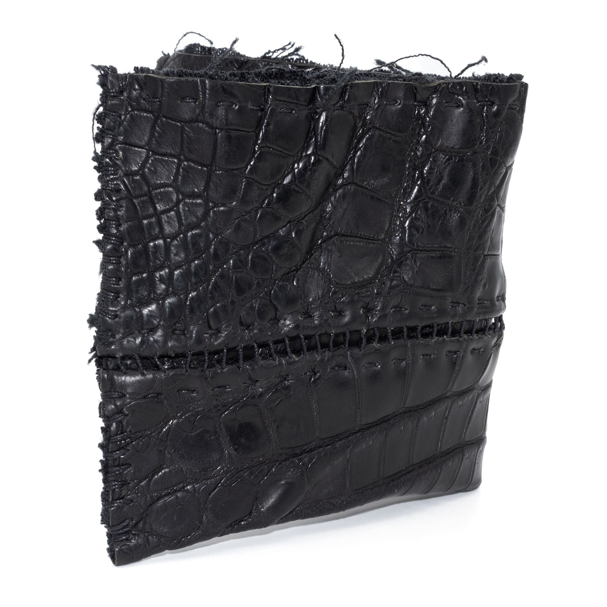 black crocodile leather wallet hand stitched over a 10 hour period. the genuine crocodile leather bifold wallet features multiple card slots, and a japanese ramie lining. an open seam construction and overlocked sides are hand stitched in a japanese linen thread. the wallet is available to buy online from avant garde leather studio atelierskn.com