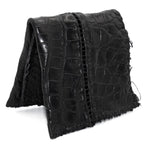 black crocodile leather wallet hand stitched over a 10 hour period. the genuine crocodile leather bifold wallet features multiple card slots, and a japanese ramie lining. an open seam construction and overlocked sides are hand stitched in a japanese linen thread. the wallet is available to buy online from avant garde leather studio atelierskn.com