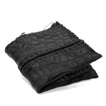 black crocodile leather wallet hand stitched over a 10 hour period. the genuine crocodile leather bifold wallet features multiple card slots, and a japanese ramie lining. an open seam construction and overlocked sides are hand stitched in a japanese linen thread. the wallet is available to buy online from avant garde leather studio atelierskn.com