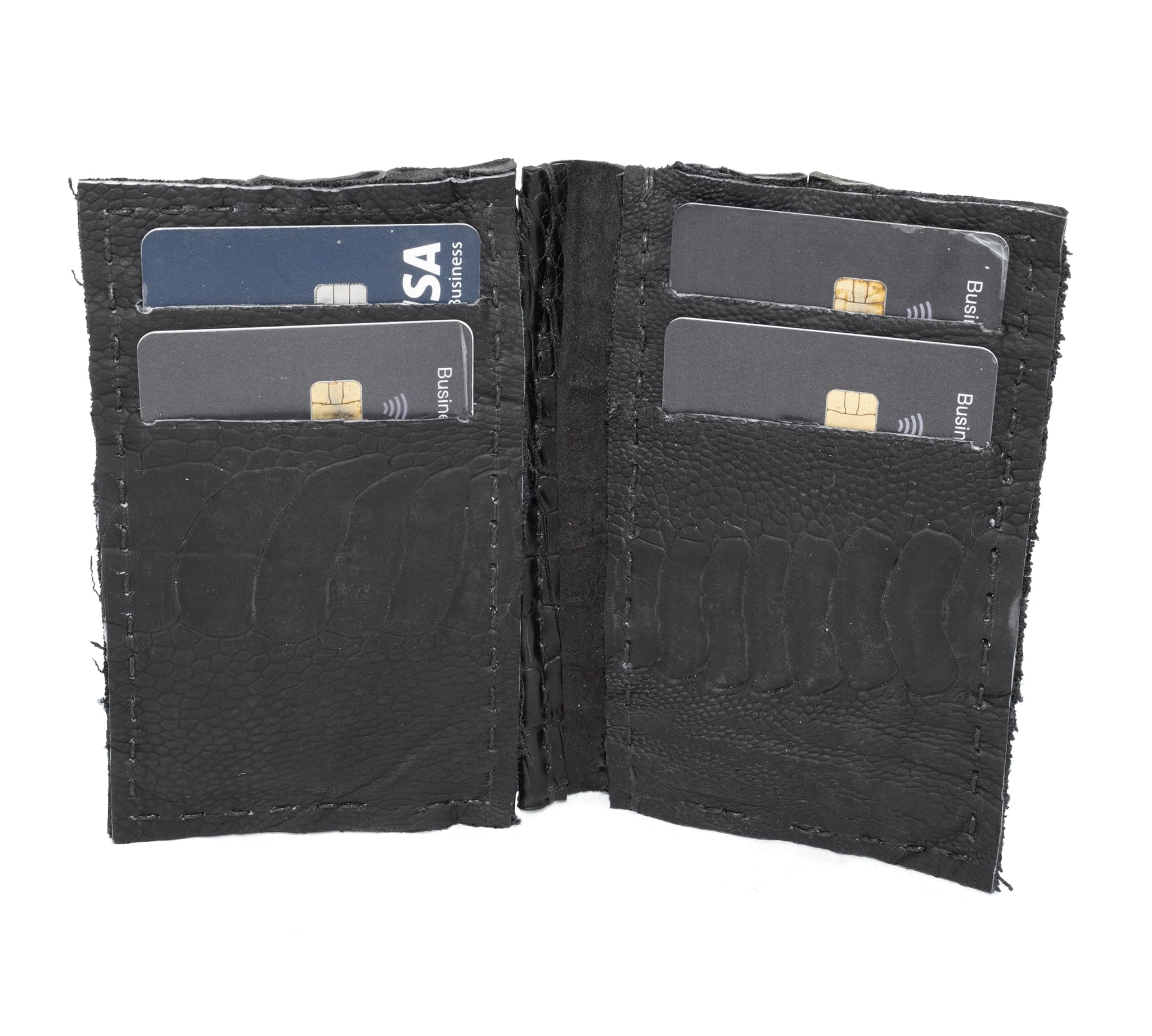 black crocodile leather cardholder, hand stitched over an 18 hour period without the use of machines. the genuine crocodile leather bifold card case features multiple card slots, and a japanese ramie lining. an open seam construction is hand stitched in a japanese linen thread. the wallet is available to buy online from avant garde leather studio atelierskn.com