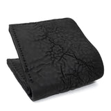 a closed seam 8 pocket bifold wallet crafted from a butter soft reverse culatta leather with a matte black object dyed finish. a riri zipper pocket is adorned with a hand forged solid .925sterling silver zipper pull available to buy online from artisanal leather studio atelierskn.com