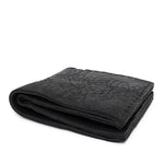a closed seam 8 pocket bifold wallet crafted from a butter soft reverse culatta leather with a matte black object dyed finish. a riri zipper pocket is adorned with a hand forged solid .925sterling silver zipper pull available to buy online from artisanal leather studio atelierskn.com