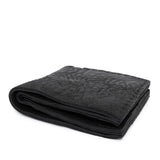 a closed seam 8 pocket bifold wallet crafted from a butter soft reverse culatta leather with a matte black object dyed finish. a riri zipper pocket is adorned with a hand forged solid .925sterling silver zipper pull available to buy online from artisanal leather studio atelierskn.com