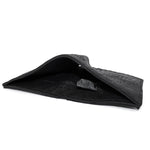 a closed seam 8 pocket bifold wallet crafted from a butter soft reverse culatta leather with a matte black object dyed finish. a riri zipper pocket is adorned with a hand forged solid .925sterling silver zipper pull available to buy online from artisanal leather studio atelierskn.com