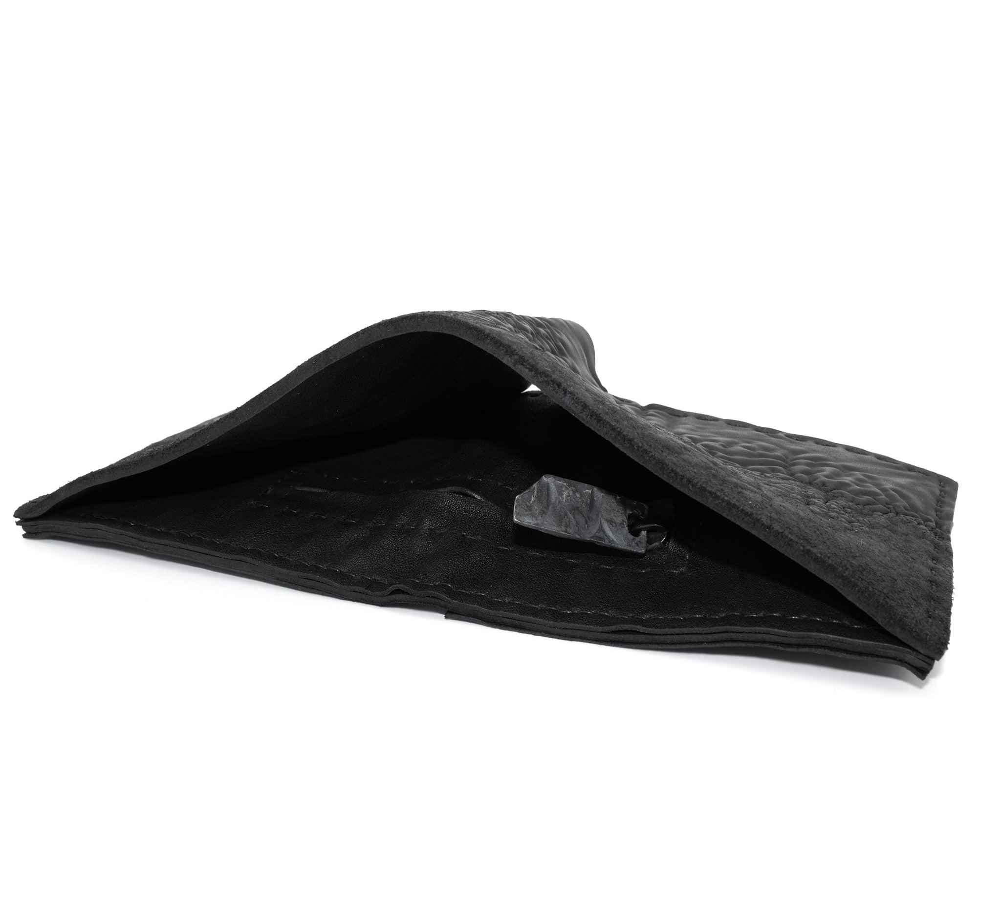 a closed seam 8 pocket bifold wallet crafted from a butter soft reverse culatta leather with a matte black object dyed finish. a riri zipper pocket is adorned with a hand forged solid .925sterling silver zipper pull available to buy online from artisanal leather studio atelierskn.com