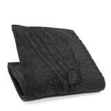 a closed seam 8 pocket bifold wallet crafted from a butter soft reverse culatta leather with a matte black object dyed finish. a riri zipper pocket is adorned with a hand forged solid .925sterling silver zipper pull available to buy online from artisanal leather studio atelierskn.com