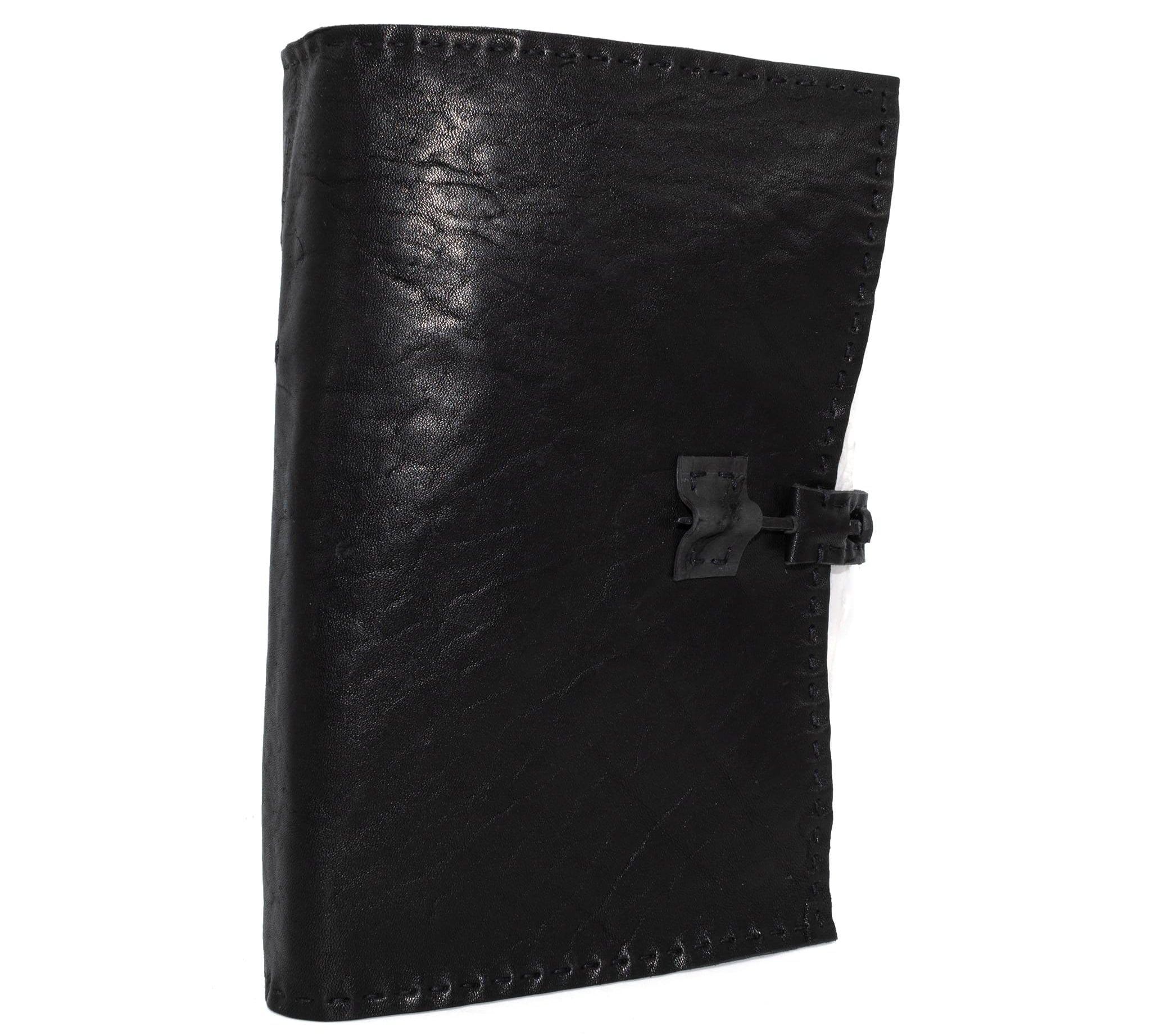 Hand stitched matte black horse culatta leather journal with a hand forged coffin nail closure and 80 pages of handmade cotton rag paper available to buy online from avant garde leather studio atelier skn.